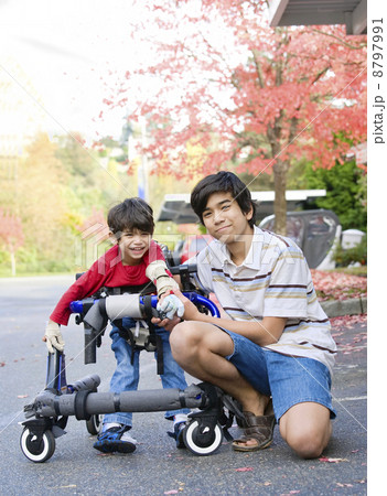 Teen boy with disabled little brother 8797991