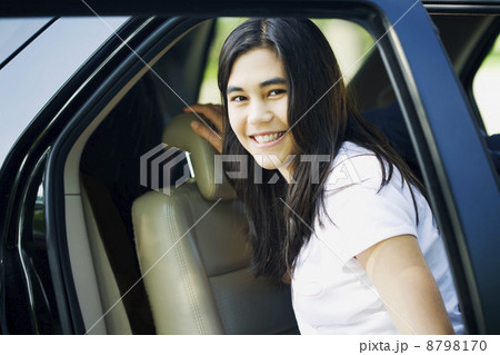 Beautiful teen girl by car door Beautiful teen girl by car door 8798170
