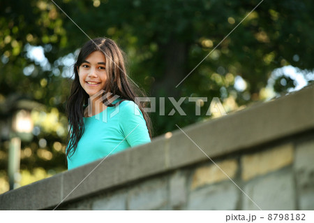 Young teen girl standing on bridge 8798182