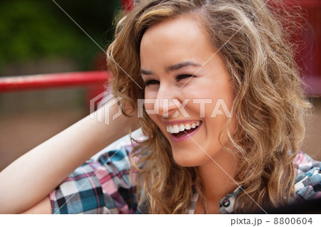 Cheerful young woman laughing Cheerful young woman laughing 8800604