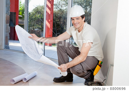 Smiling man with blueprint Smiling man with blueprint 8800696