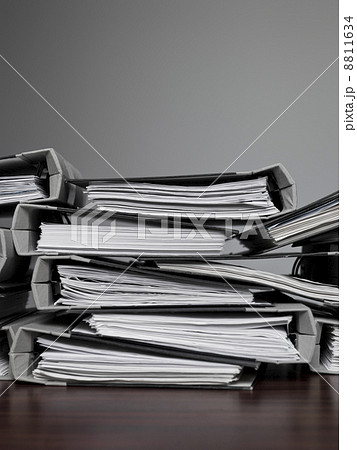 files stacked on a desk 8811634