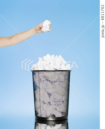 trowing a paper into a wastebasket trowing a paper into a wastebasket 8811762