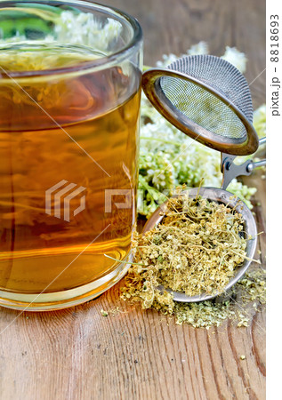 Herbal tea from meadowsweet dry in a strainer with a mug Herbal tea from meadowsweet dry in a strainer with a mug 8818693