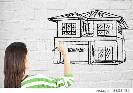 woman draw house on brick wall woman draw house on brick wall 8833459