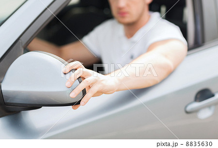 man ajusting rear view mirror man ajusting rear view mirror 8835630