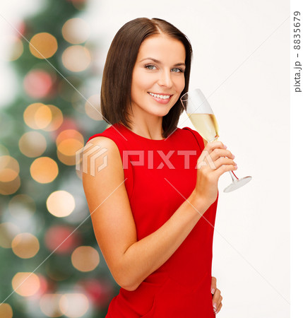 woman in red dress with a glass of champagne 8835679