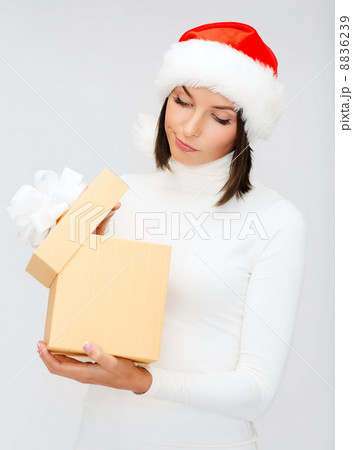 suspicious woman in santa helper hat with gift box 8836239