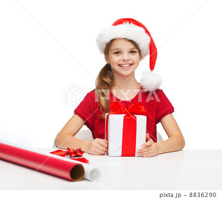 smiling girl in santa helper hat with gift box smiling girl in santa helper hat with gift box 8836290
