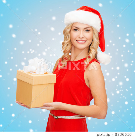 smiling woman in santa helper hat with gift box 8836616