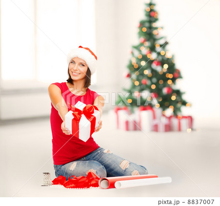 smiling woman in santa helper hat with gift box smiling woman in santa helper hat with gift box 8837007