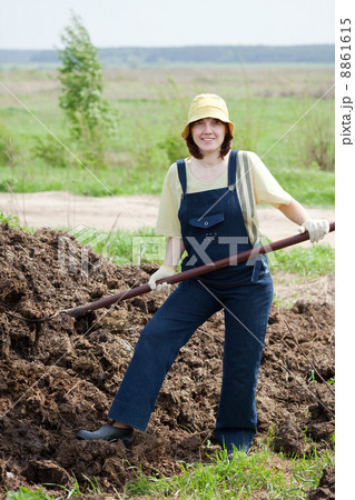farmer works with manure at field farmer works with manure at field 8861615