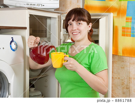 woman pouring cool fruit-drink 8861788