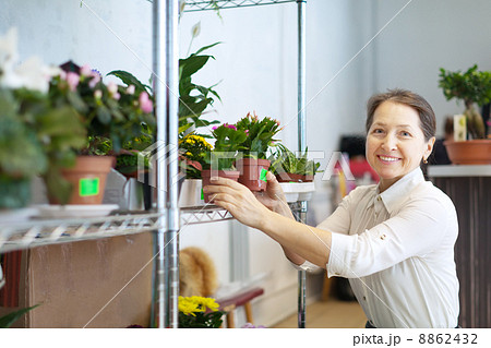 mature woman with Schlumbergera plant 8862432