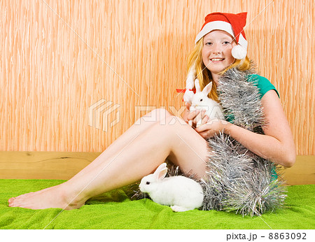 girl in new year decoration with rabbits 8863092