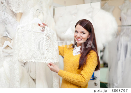 woman chooses wedding dress 8863797