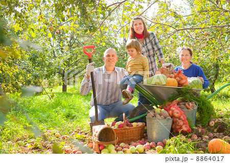 Happy family with harvest in garden Happy family with harvest in garden 8864017