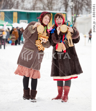 Women tasting pancake during Shrovetide 8864681