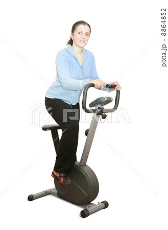 Girl workout on stationary bicycle 8864852