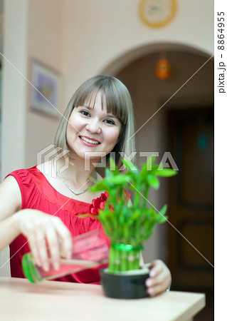 Girl with lucky bamboo plant Girl with lucky bamboo plant 8864955