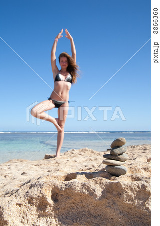 Balanced stones and girl doing yoga Balanced stones and girl doing yoga 8866360