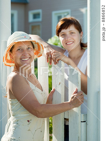 happy women near fence wicket 8866852