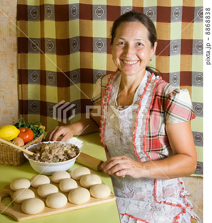 woman cooking meat pasty woman cooking meat pasty 8868838