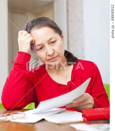 woman reads payments at home woman reads payments at home 8868932