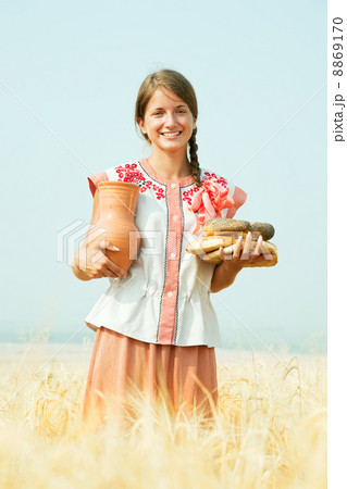 Girl with bread at rye field 8869170