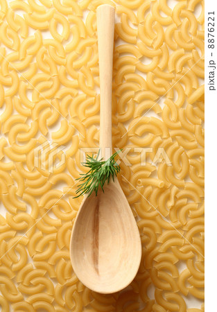Pasta tubes background with spoon and dill Pasta tubes background with spoon and dill 8876221