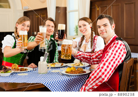 People in traditional Bavarian Tracht eating in restaurant or pub People in traditional Bavarian Tracht eating in restaurant or pub 8890238