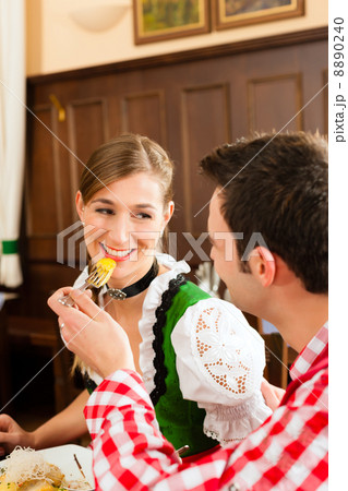 People in traditional Bavarian Tracht eating in restaurant or pub People in traditional Bavarian Tracht eating in restaurant or pub 8890240