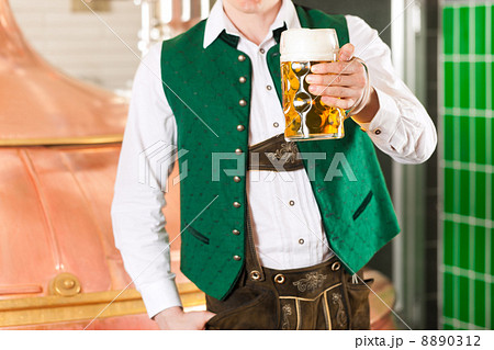 Man with beer glass in brewery 8890312