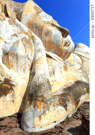 giant reclining buddha face statue over blue sky 8909737