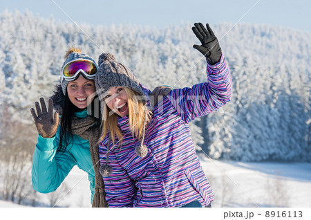 Two female friends winter snow in mountains 8916113