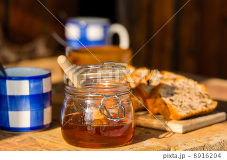 Tea, honey and fruit bread on wooden table 8916204