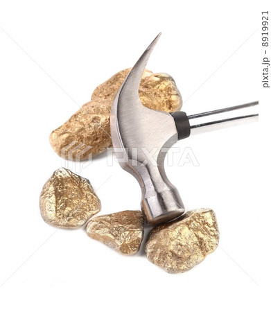 Closeup of metal hammer with gold nuggets. 8919921