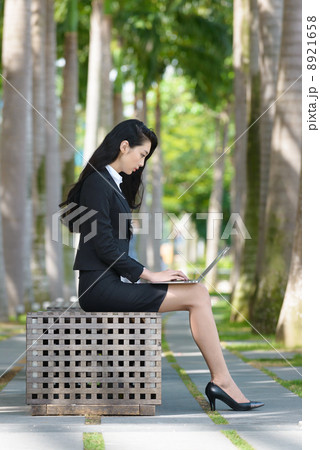 Young Office Lady using laptop outdoor 8921658