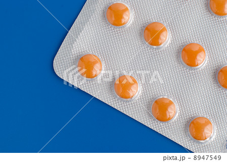 Close-up of a pack of orange pills Close-up of a pack of orange pills 8947549