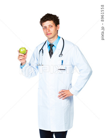 Portrait of a male doctor holding green apple on white 8961558