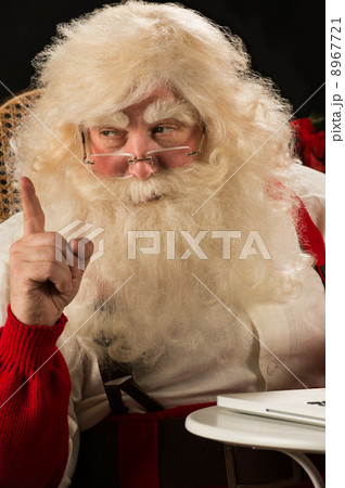 Santa Claus working on computer and having great idea Santa Claus working on computer and having great idea 8967721