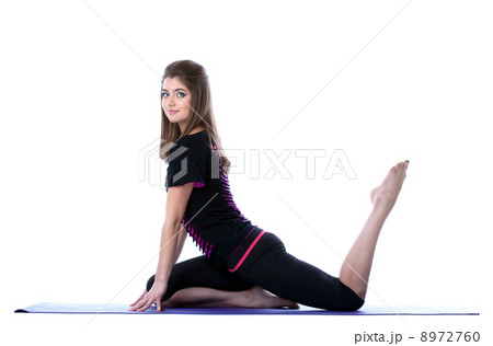 Studio shot of beautiful sporty girl posing on mat Studio shot of beautiful sporty girl posing on mat 8972760