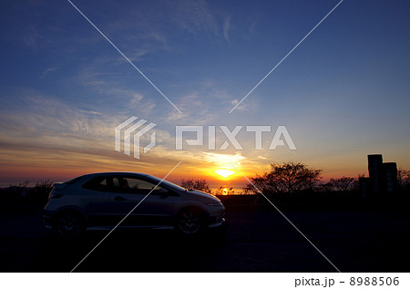 西伊豆に沈む太陽とスポーツカー 8988506