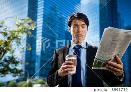 Businessman in the City reading Papers Businessman in the City reading Papers 8991756