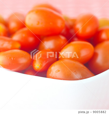 cherry tomatos in bowl on checkered fabric 9005882