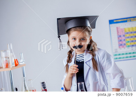 Adorable little girl posing with fake mustache Adorable little girl posing with fake mustache 9007659