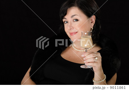 Woman with a glass of cream liqueur 9011861