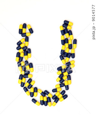 The letter U alphabet made of medical capsules 9014577
