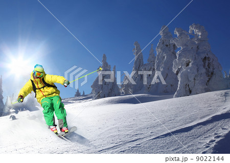 Skier skiing downhill in high mountains Skier skiing downhill in high mountains 9022144