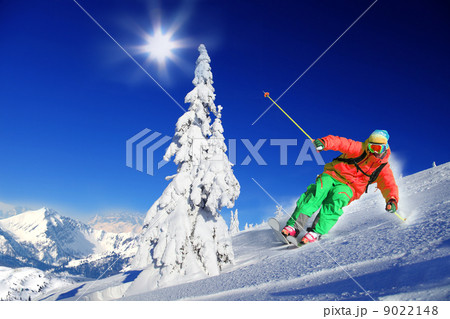 Skier skiing downhill in high mountains Skier skiing downhill in high mountains 9022148